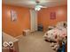 Bedroom with carpeted floors, orange walls, ceiling fan, and princess-themed decor throughout the room at 1711 Jaques Dr, Lebanon, IN 46052