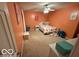 Cozy bedroom featuring orange walls, carpet floors and stuffed animals at 1711 Jaques Dr, Lebanon, IN 46052