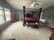 Spacious bedroom with a four-poster bed, ceiling fan, and ample natural light at 1711 Jaques Dr, Lebanon, IN 46052