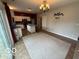 Bright dining area with access to the backyard and a modern light fixture at 1711 Jaques Dr, Lebanon, IN 46052