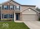 Two-story home with brick and vinyl siding, complemented by a well-maintained lawn at 1711 Jaques Dr, Lebanon, IN 46052