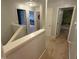 Upstairs hallway with carpeting, neutral paint, and access to bedrooms and other living areas in the home at 1711 Jaques Dr, Lebanon, IN 46052