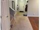 Hallway with carpet and vinyl flooring leading to the home entrance at 1711 Jaques Dr, Lebanon, IN 46052