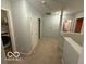 Upstairs hallway featuring a laundry area and multiple doorways at 1711 Jaques Dr, Lebanon, IN 46052