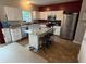 Well-lit kitchen features granite countertops, stainless steel appliances and an island at 1711 Jaques Dr, Lebanon, IN 46052