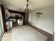 Open kitchen with a stainless steel refrigerator, white cabinets and island with granite countertops at 1711 Jaques Dr, Lebanon, IN 46052