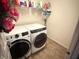 Bright laundry room with newer washer and dryer and shelving at 1711 Jaques Dr, Lebanon, IN 46052