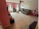 Carpeted living room with couch, ceiling fan and play area at 1711 Jaques Dr, Lebanon, IN 46052