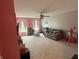 Carpeted living room with couch, ceiling fan and play area at 1711 Jaques Dr, Lebanon, IN 46052