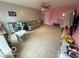 Open living room with neutral carpet, a sofa and toys and table set at 1711 Jaques Dr, Lebanon, IN 46052
