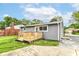 Backyard view showcasing a gray home with a charming wooden deck and sunny skies at 1820 Hemlock Ln, Plainfield, IN 46168