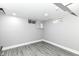 Unfinished basement featuring modern gray vinyl flooring and freshly painted walls at 1820 Hemlock Ln, Plainfield, IN 46168