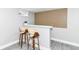 Finished basement features a bar with two chairs, light gray paint and wood accent wall at 1820 Hemlock Ln, Plainfield, IN 46168