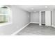 Basement with gray walls, wood floors, a closet with sliding doors and a window at 1820 Hemlock Ln, Plainfield, IN 46168