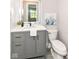 Modern bathroom with gray vanity, stylish fixtures, and decorative illuminated mirror at 1820 Hemlock Ln, Plainfield, IN 46168
