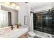Modern bathroom featuring black tile shower, toilet, sink and marble countertop at 1820 Hemlock Ln, Plainfield, IN 46168