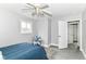 Bedroom featuring a ceiling fan, window, and doorway leading to another room at 1820 Hemlock Ln, Plainfield, IN 46168