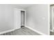 Bedroom with grey walls, wood floors, white trim and closet with sliding doors at 1820 Hemlock Ln, Plainfield, IN 46168