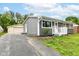 Charming single-story home with gray siding, white trim, well-maintained lawn, and a detached two car garage at 1820 Hemlock Ln, Plainfield, IN 46168