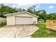 View of detached garage with a large door and concrete driveway at 1820 Hemlock Ln, Plainfield, IN 46168