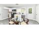 Eat-in kitchen featuring white cabinets, modern appliances, a glass dining table, and view to the backyard at 1820 Hemlock Ln, Plainfield, IN 46168
