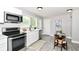 Bright kitchen features stainless steel appliances, white cabinets, and a dedicated dining area at 1820 Hemlock Ln, Plainfield, IN 46168