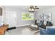 Well-lit living room with gray walls, stylish decor, comfortable seating, and view to the front yard at 1820 Hemlock Ln, Plainfield, IN 46168