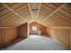 Attic features wood paneling, a carpeted floor, and a window for natural light at 1915 Albany St, Beech Grove, IN 46107