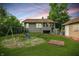 Backyard featuring a playset and a view of the house with dusk sky in the background at 1915 Albany St, Beech Grove, IN 46107