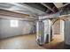 Basement mechanical room with water heater, exposed beams and a small window at 1915 Albany St, Beech Grove, IN 46107