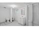 Basement bathroom features a toilet, vanity, mirror and unique glass block window at 1915 Albany St, Beech Grove, IN 46107