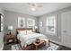 Cozy bedroom features a wood frame bed, stylish rug, and two windows for natural light at 1915 Albany St, Beech Grove, IN 46107