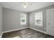 Bright bedroom features wood flooring, two windows, and a ceiling fan with lighting at 1915 Albany St, Beech Grove, IN 46107