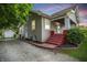 Charming home with red steps, landscaped yard, and detached garage at 1915 Albany St, Beech Grove, IN 46107
