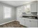 Well-lit kitchen featuring white cabinets and dark countertops at 1915 Albany St, Beech Grove, IN 46107
