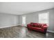 Cozy living room with hardwood floors, bright walls, and a comfortable red sofa at 1915 Albany St, Beech Grove, IN 46107