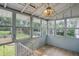Enclosed back porch with multi-pane windows and a chandelier-style light fixture at 1915 Albany St, Beech Grove, IN 46107