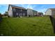 A large backyard, enclosed by a black chain link fence, offering plenty of space for outdoor activities and relaxation at 1981 Turning Leaf Dr, Franklin, IN 46131