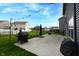 A backyard with a concrete patio, covered grill, swing set, and strung lights is ideal for outdoor activities at 1981 Turning Leaf Dr, Franklin, IN 46131
