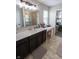 Well-lit bathroom with a double vanity, shower, and a view into the bedroom at 1981 Turning Leaf Dr, Franklin, IN 46131