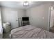 Neutral bedroom features a comfortable bed, a flat-screen television, and access to an upper level of the home at 1981 Turning Leaf Dr, Franklin, IN 46131