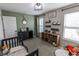 Bright bedroom featuring a crib, ample storage, and playful decor at 1981 Turning Leaf Dr, Franklin, IN 46131