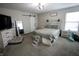 Cozy bedroom featuring a barn door, a queen-size bed, and coordinating furniture at 1981 Turning Leaf Dr, Franklin, IN 46131