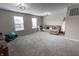 Spacious bonus room with neutral tones, carpet, and plenty of natural light from large windows at 1981 Turning Leaf Dr, Franklin, IN 46131