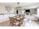 Inviting dining area showcasing a wooden table with seating for four and stylish light fixture at 1981 Turning Leaf Dr, Franklin, IN 46131