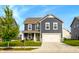 Charming two-story home features a well-manicured lawn and attached two car garage at 1981 Turning Leaf Dr, Franklin, IN 46131