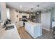 Bright kitchen with white cabinetry, island seating, and stainless steel appliances at 1981 Turning Leaf Dr, Franklin, IN 46131