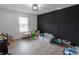Spacious playroom with natural light, modern floors, and stylish black paneled accent wall at 1981 Turning Leaf Dr, Franklin, IN 46131