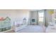 Bright bonus room with a window, play easel, toy train set, and delightful painted house decals at 2040 White Oak Dr, Shelbyville, IN 46176