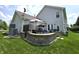 A lovely backyard with patio, retaining wall, seating, landscaping, and grass at 2303 Eagle Brook Dr, Shelbyville, IN 46176